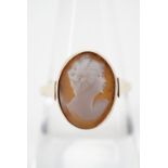 An antique carved shell cameo ring, depicting the profile of a fashionable young lady, millegrain