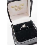 A contemporary 18ct white gold diamond solitaire ring, having a brilliant-cut diamond of