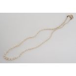 A vintage single strand necklace of graded pearls, on a yellow-metal clasp, stamped '9ct', tests