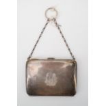 A George V silver ring purse, of rounded rectangular form, with an engraved Gothic monogram, opening