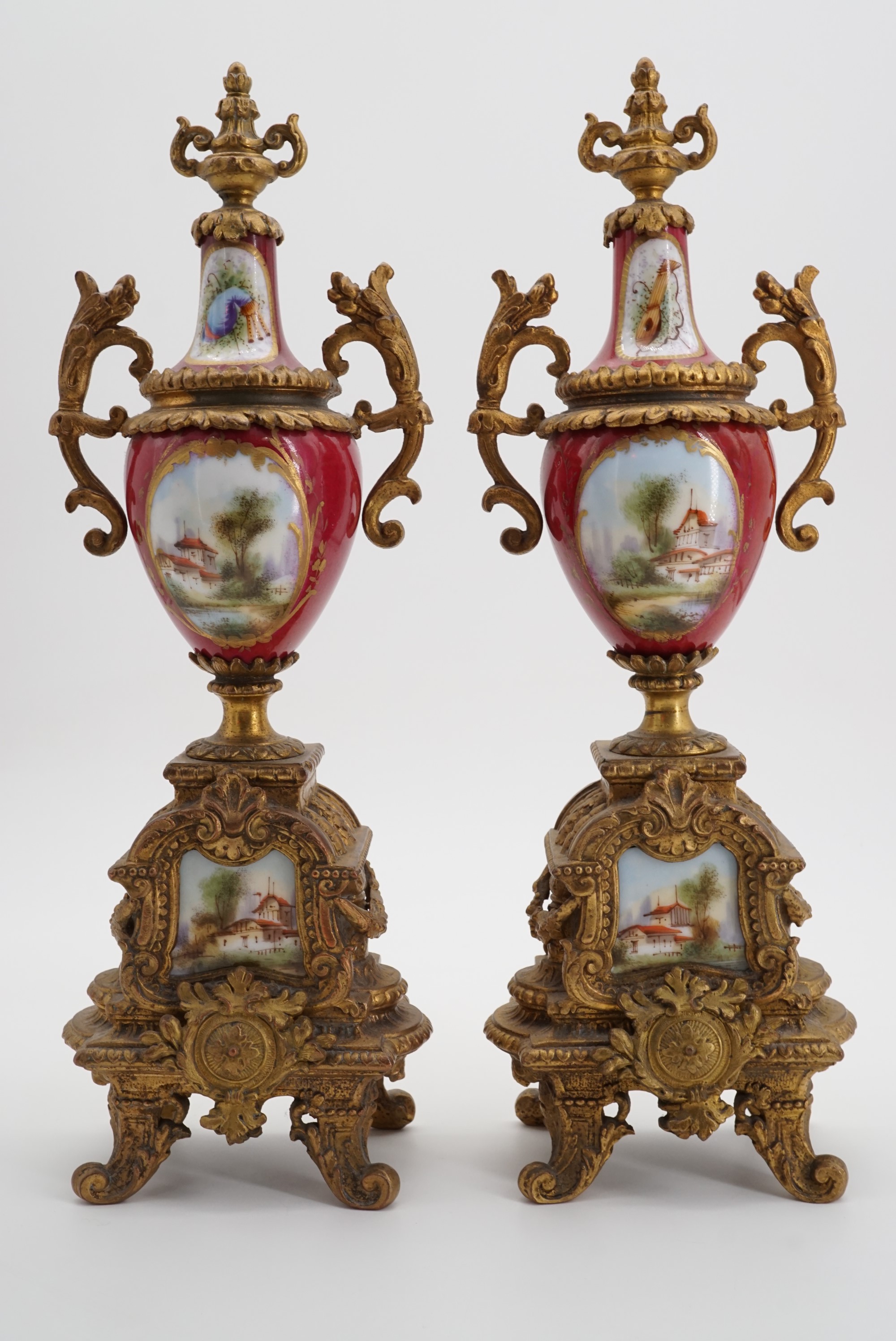 A pair of late 19th Century ormolu-mounted garniture urns, each oviform with flamboyant neo-