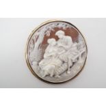 A shell cameo pendant brooch by Giovanni Noto, bass relief carved in depiction of two lovers in a