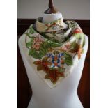 A vintage Liberty of London 'Je Me Souviens' silk scarf, decorated with bold blossoms and coats of