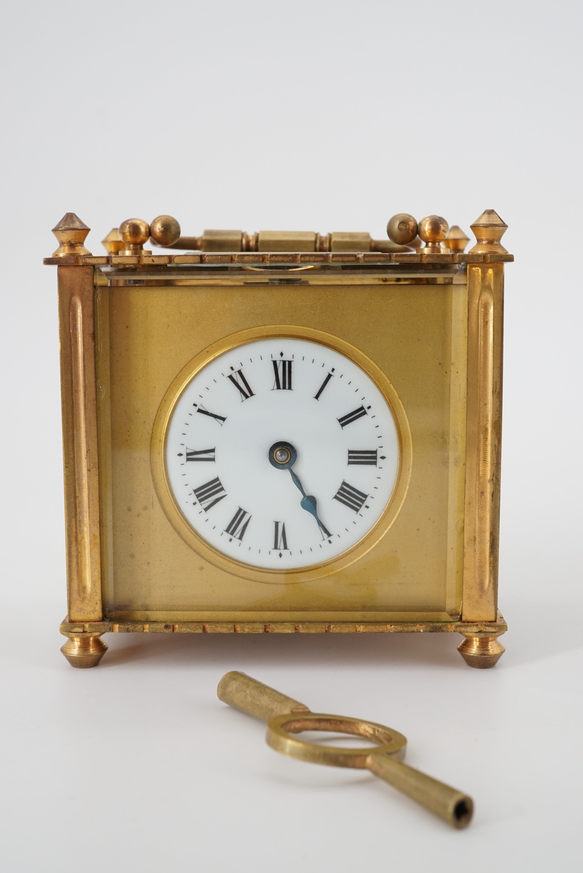 A late 19th Century French carriage clock of squat proportions, in transit case, 9 cm high excluding