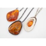 Three Latvian amber nodule pendant necklaces, suspended on base metal chains, largest nodule