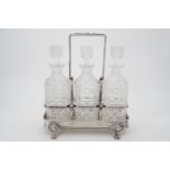 A 19th Century electroplate decanter stand and three cut glass decanters, 31 cm high (to top of