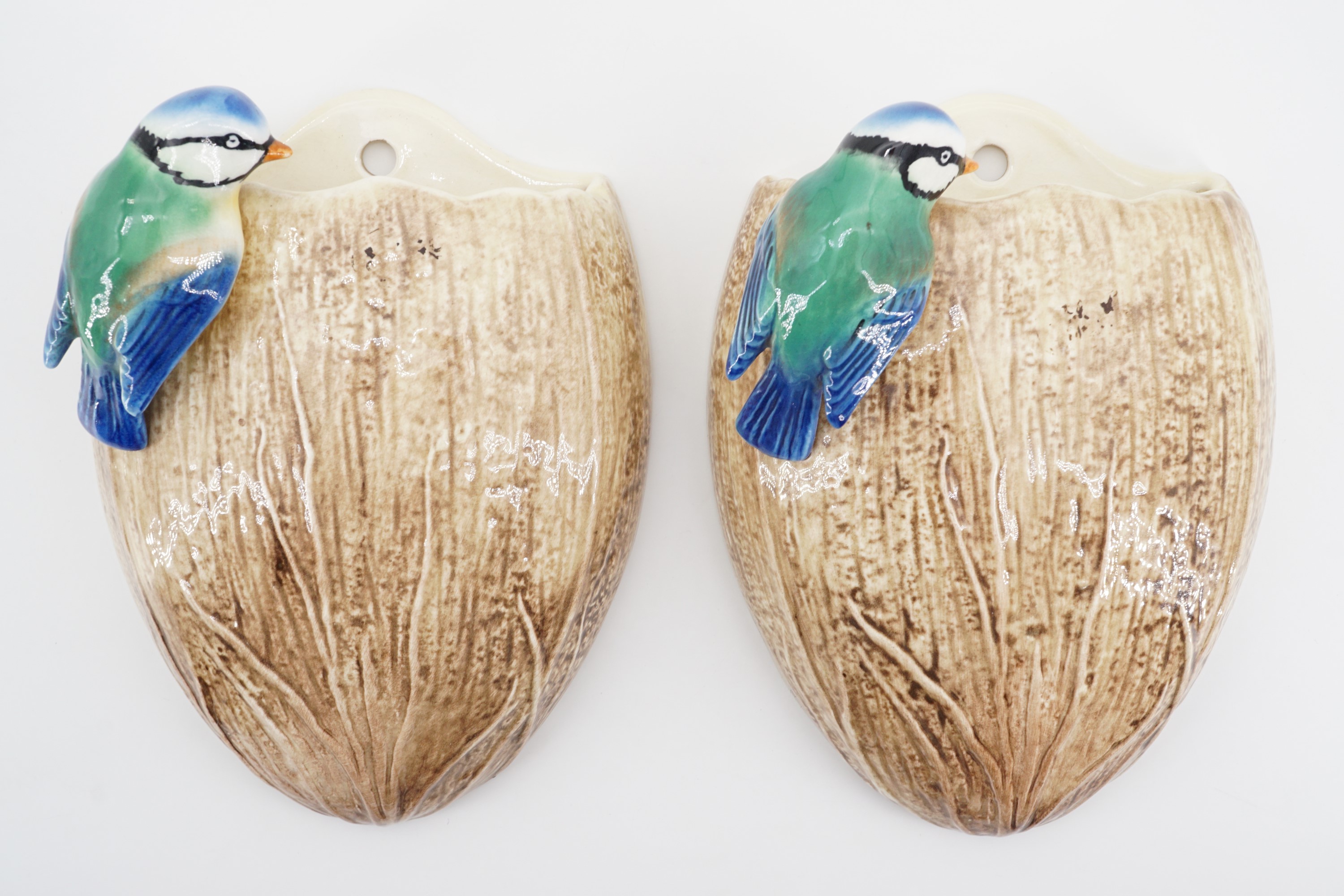 A pair of Sylvac wall pockets modelled as a blue tit perched on a coconut, pattern No 687, 20 cm