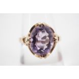 A 9ct gold and amethyst cocktail ring, the oval faceted stone of approximately 2.4ct, claw-set