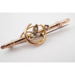 An antique rose gold and seed pearl bar brooch, the whipped bar surmounted by a crescent moon and