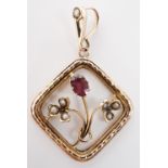 A Belle Epoque antique almandine garnet and split seed pearl openwork pendant, having a whiplash