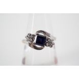 A sapphire and diamond twist set dress ring, with central princess cut sapphire of approximately .