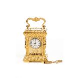 Reloj de carruaje Trigona en cristal y metal dorado cincelado con decoración floral y esfinges,