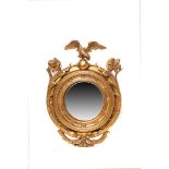 Espejo estilo Regency inglés en madera tallada y dorada con decoración floral y rematado por águila,