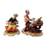 Hombre tocando el piano y Anciana con paloma. Pareja de figuras en biscuit Capodimonte, mediados del