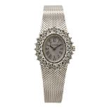 Reloj Longines de pulsera para señora. En oro blanco y doble orla de diamantes talla brillante