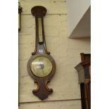 Victorian figured mahogany wheel barometer with silvered dials