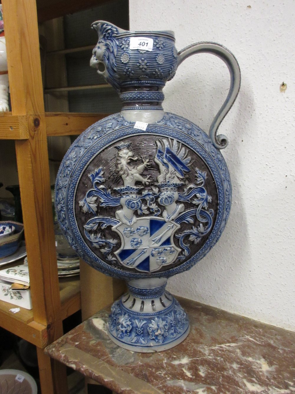 Large German stoneware ewer relief moulded with crests and mask heads