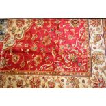 Red ground Kashan pattern machine carpet, 2.3m x 1.