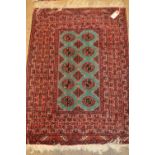 Small Turkoman style rug with two rows of five gols on a green ground together with two similar