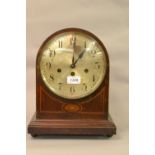 Edwardian mahogany and inlaid dome shaped mantel clock with a silvered dial,
