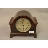 Early 20th Century mahogany mantel clock with a circular silvered dial,