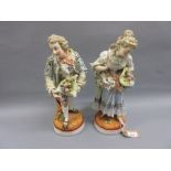 Pair of large late 19th Century Continental porcelain figures of a boy and girl wearing floral
