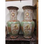 Pair of large Chinese stoneware baluster form vases decorated with figures of dragons within panels,