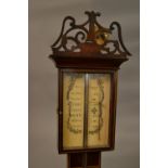 Reproduction mahogany and inlaid stick barometer together with a carved oak aneroid barometer