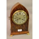 Edwardian oak and chequer inlaid lancet shaped mantel clock with a silvered dial,