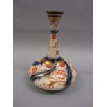 Macintyre Burslem narrow neck vase, decorated with a stylised floral design in iron red,