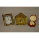 Looping gilt metal eight day travel clock in a leather case,