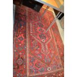 Hamadan rug with lobed medallion and floral design on red ground with borders,