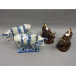 Pair of Continental pottery floral decorated figures of cows,