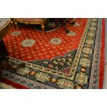 Good quality Chinese carpet with a medallion design on a red ground with borders,