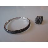 Modern silver and black spinel bangle together with a matching ring