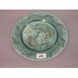 Early 20th Century circular wall plate painted with stylised fish, signed to the reverse Gertrude M.