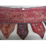 Indian embroidered over door hanging on mauve ground