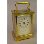 Gilt brass carriage clock, the enamel dial with Roman and Arabic numerals inscribed Taylor & Bligh,