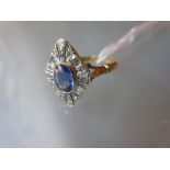 18ct Yellow gold ring set oval sapphire surrounded by baguette and round diamonds