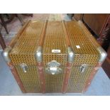 20th Century tin covered wooden bound trunk with hinged cover and side carrying handles,