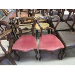 Two pairs of William IV rosewood kidney back dining chairs with overstuffed seats and turned