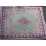 Large mid 20th Century Indian carpet with a medallion and floral design on a pale green ground with