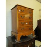 Small reproduction yew wood four drawer bedside chest,