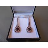 Pair of platinum Art Deco style ruby and diamond drop earrings, the rubies of approximately 4.