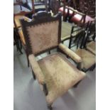 Late Victorian carved walnut and upholstered elbow chair on turned front supports,