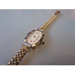 Ladies 18ct gold cased enamel decorated wristwatch with a 9ct gold bracelet strap (at fault)