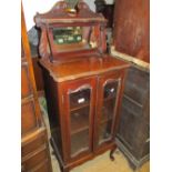 Edwardian mahogany music cabinet with a mirrored back above two glazed doors on cabriole supports