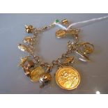 9ct Gold charm bracelet set various charms including a 1958 sovereign CONDITION REPORT