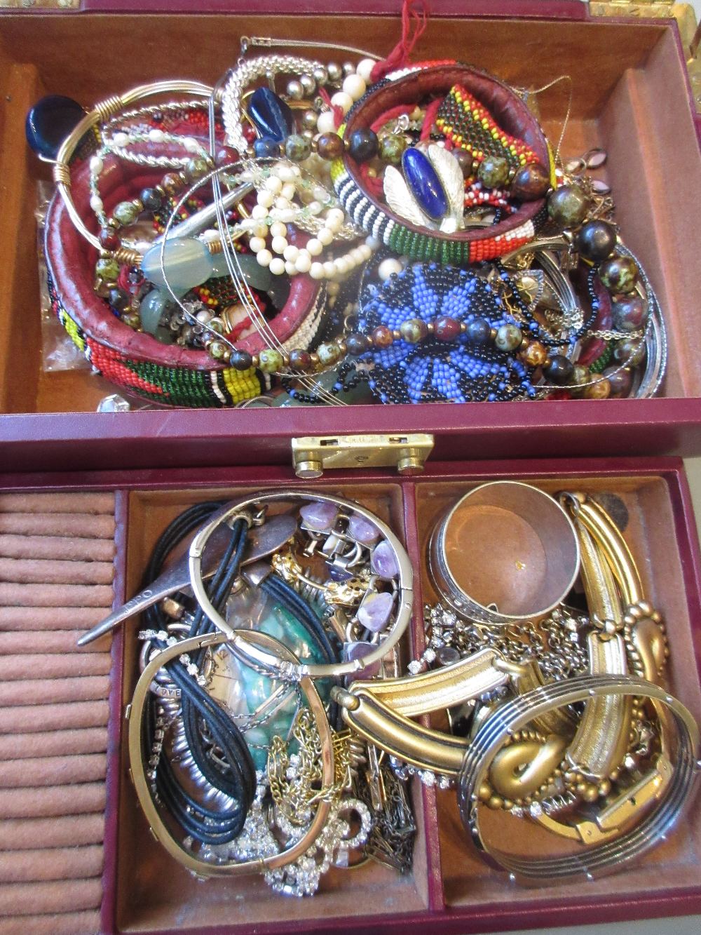 Two jewellery boxes containing a quantity of various costume jewellery including an amber coloured