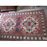 Modern Kazak rug with two centre medallions with multiple borders on a terracotta ground,